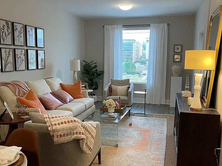 Spacious Living Area with Wood Floors & Private Balcony Access