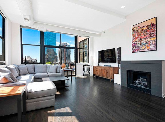 The large living room opens to a gas fireplace and large private terrace.
