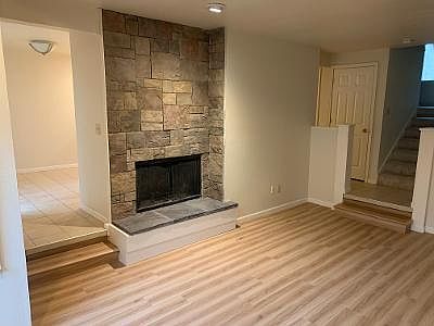 Living room, fireplace, and stairs