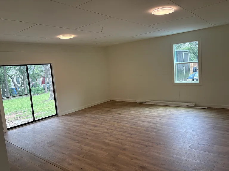 Large storage room (former garage) with W/D laundry hook up and a storage closet