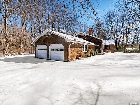 Side exterior picture of 65 Hunting Hill Rd. Note the 2 car garage.