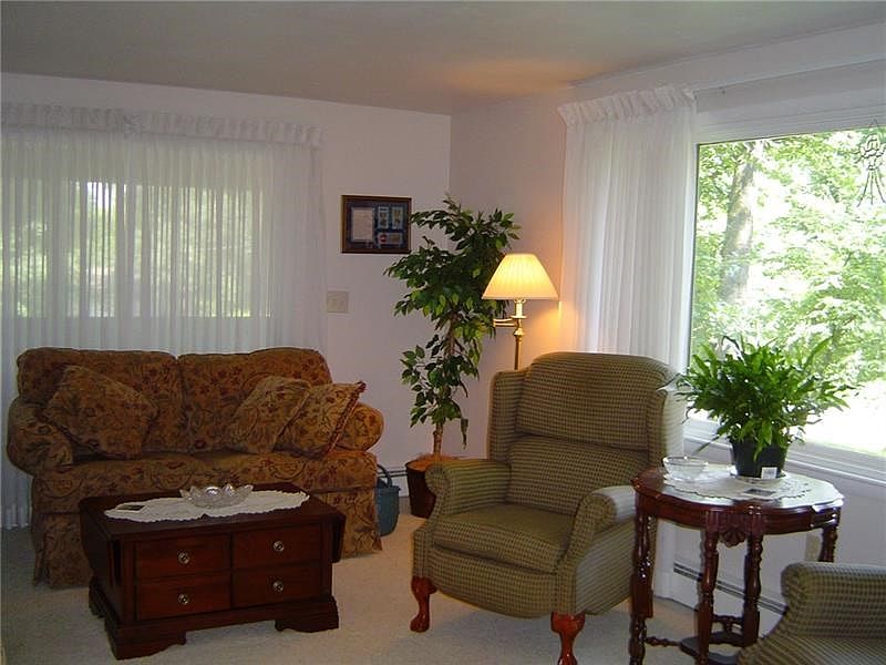 This bright living room has a sliding door leading to the screened porch.
