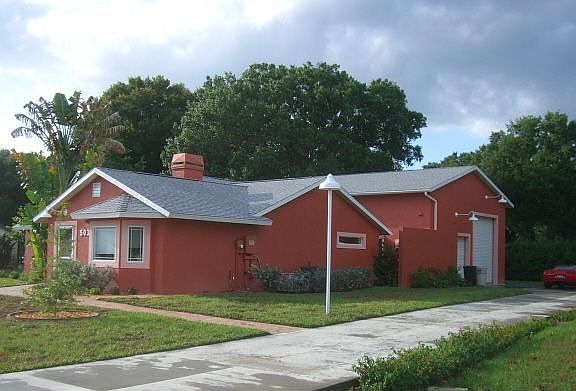 Front and side of house with generator, garage, and garden