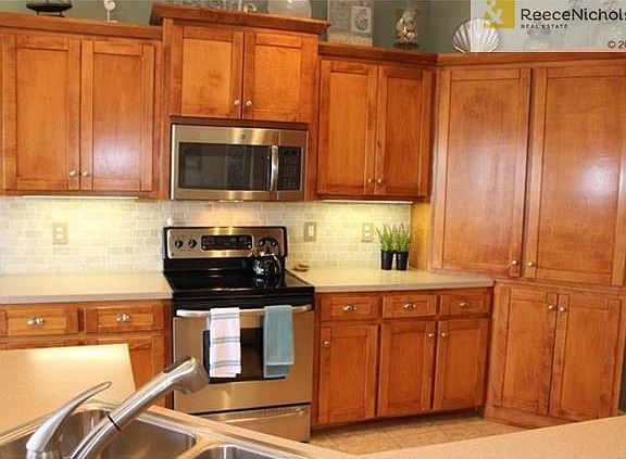 Custom Maple Cabinetry with Cupboard Pantry offer fantastic storage.  Stainless Steel Appliances.