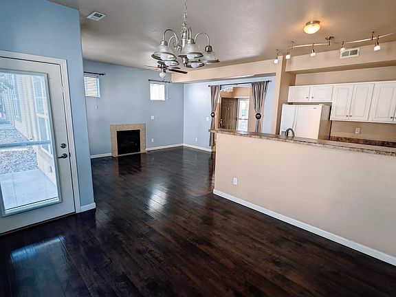 Picture of the open floor plan from the dining area. Door on the left leads to the back patio.