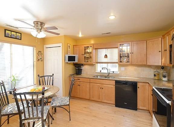 This beautifully appointed kitchen features custom cabinetry and granite counter tops.
