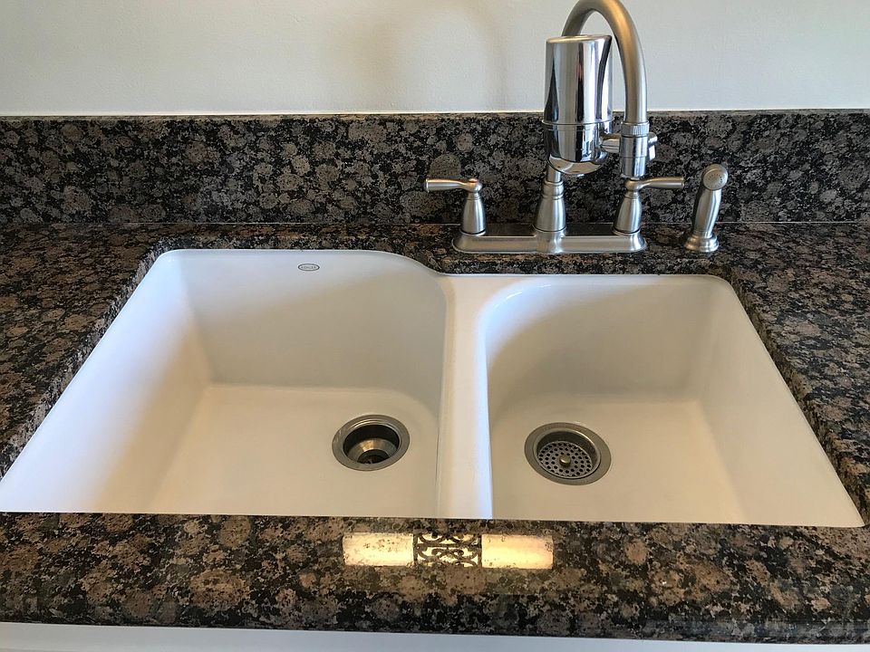 High-end new porcelain sink with upscale faucet and spray.