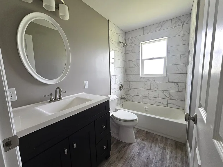 Main bath with ceramic tub/shower and nice-sized vanity