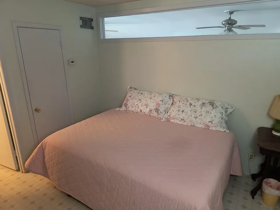 Queen size bed and nightstand There is a television on the bureau that you cannot see.