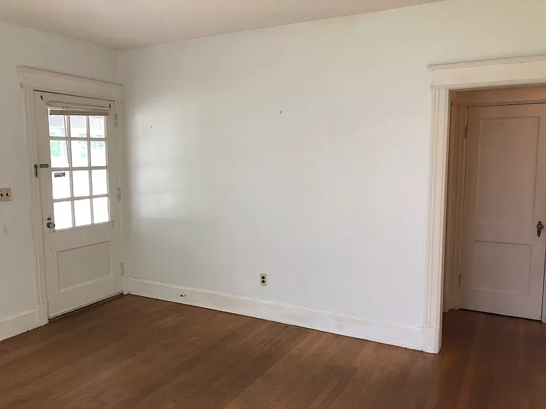Front door, doorway leading to hallway with 2 bedrooms and 1 bath