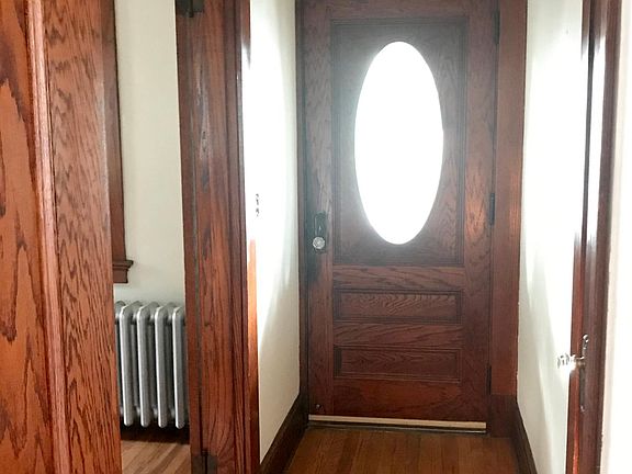 View of front door from front hallway. French doors are to the left (to right when walking in) which lead to living room.