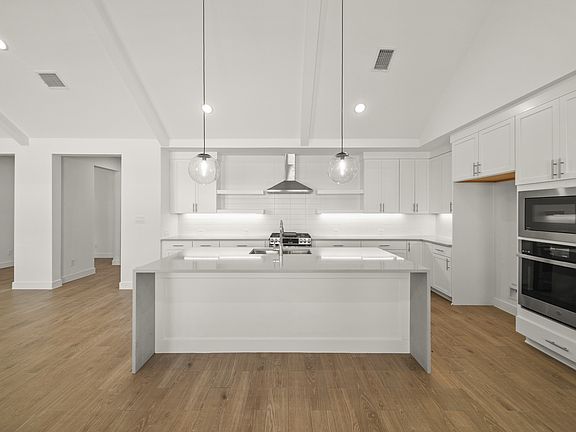 Kitchen featuring center island with waterfall edge