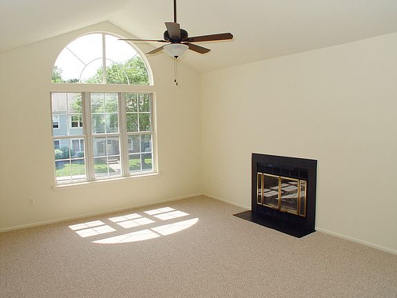 Living room with Palladian window and cathedral ceiling.