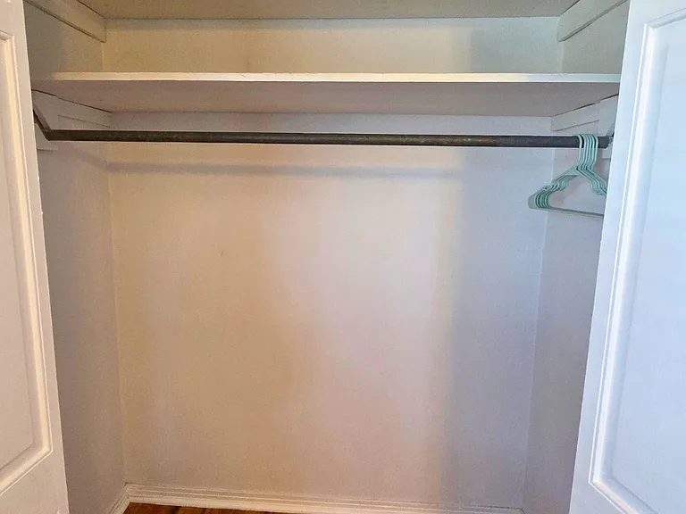 Spacious open closet with hangers for your belongings.