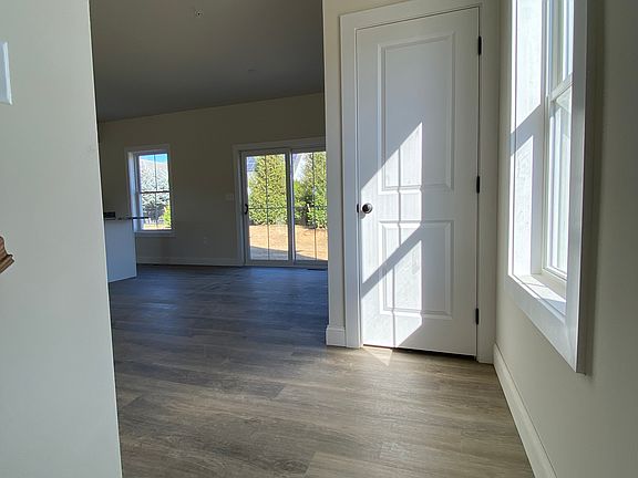 As you approach from the garage, coat closet at the top of the stairs, patio entrance and kitchen to the left