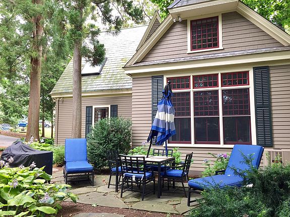 PATIO TUCKED UNDER THE TREEES