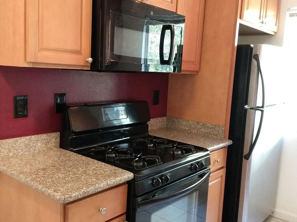 Efficient full sized gas stove, multi function microwave, good sized deep refrigerator/ice maker, caramel colored cabinets.