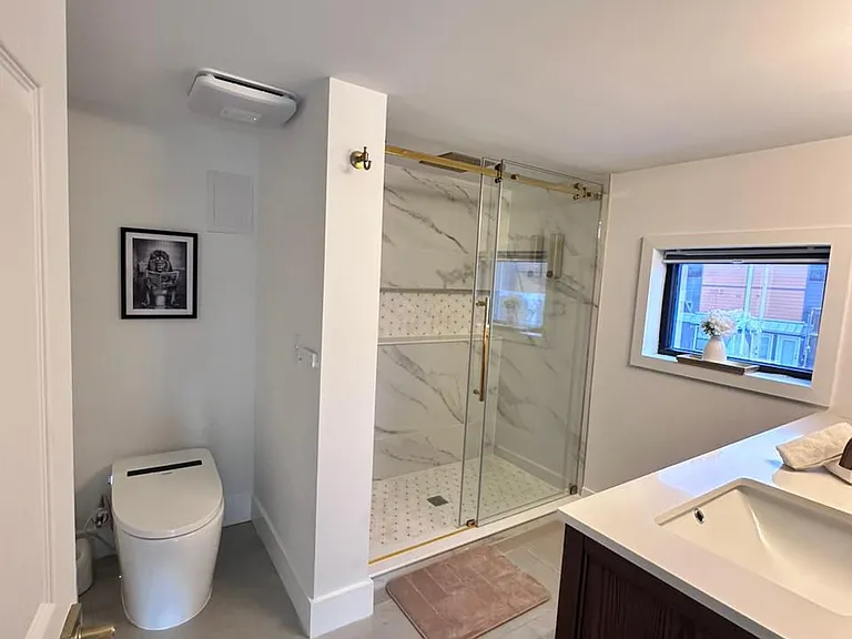 Modern bathroom with premium tilework, a smart toilet, and upscale finishes.