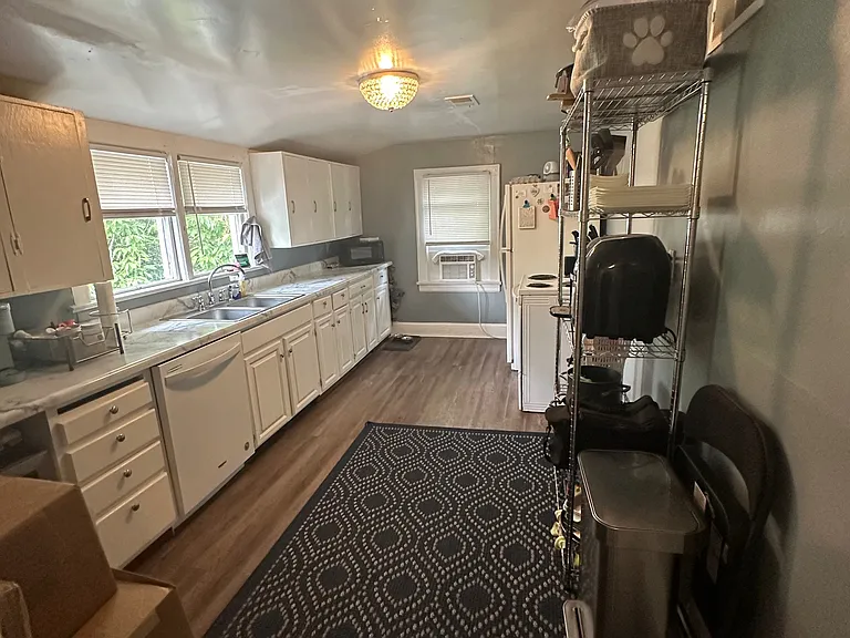 PRIOR TO NEW LUXURY VINYL TILE!
Previous Photo prior to new paint - Kitchen w/ Beautiful Crystal Lighting, Designer Paint and New Countertops. New Stainless Cabinet Knobs.
*Apartment has been painted w/ Sherwin Williams French Gray!*