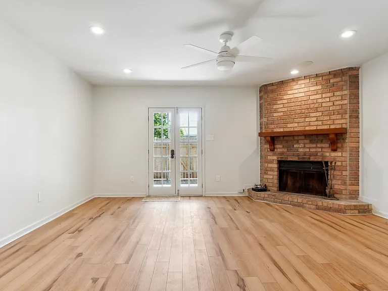 Spacious den with working fireplace. Built in speakers in the ceilings and connections for HDTV. Brand new ceiling fan with remote control.
