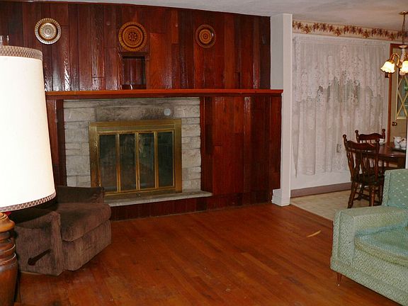 Living room features stone fireplace
