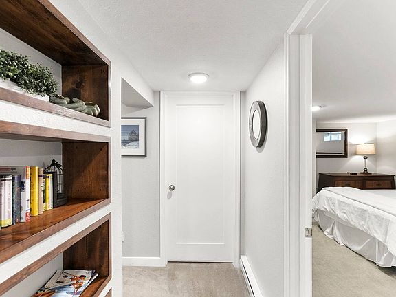 Hallway to bedrooms, bathroom, closet, and laundry. Door ahead is a storage closet that stays locked.