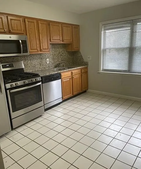 Kitchen has two large windows as well to let in natural lighting.