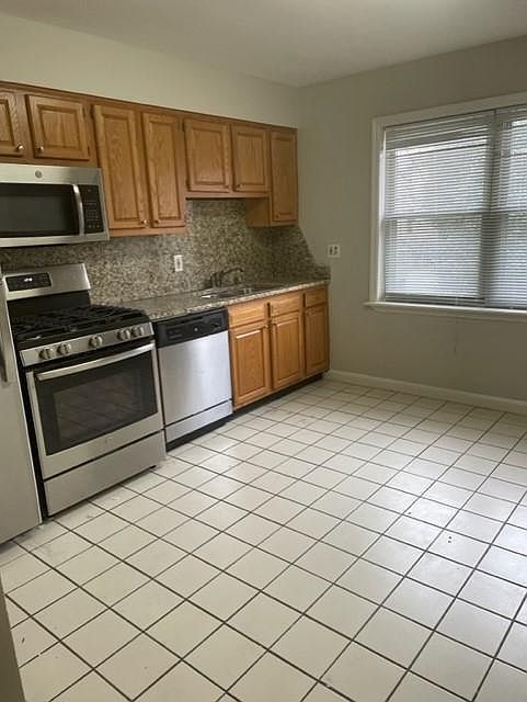 Kitchen has two large windows as well to let in natural lighting.