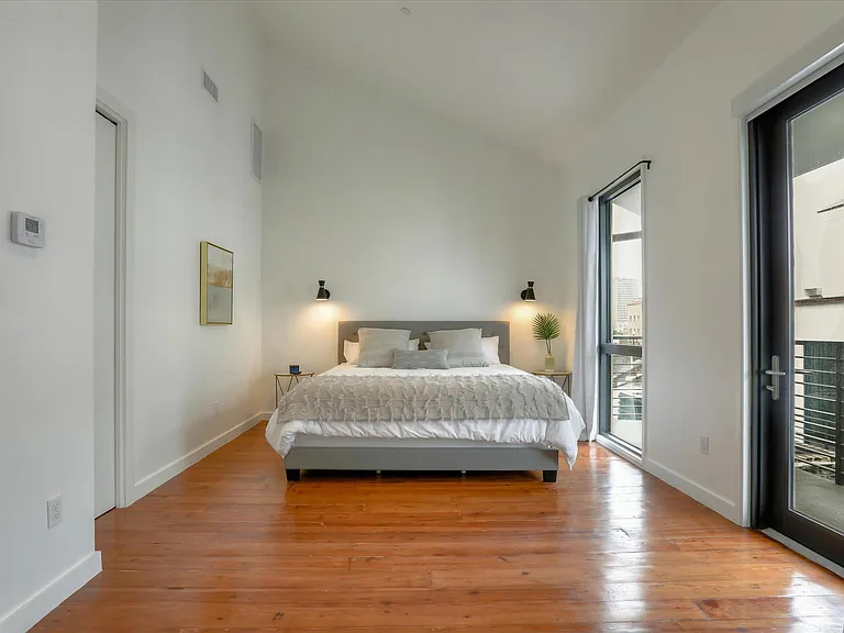The master bedroom on the third floor has a king bed and a terrace with views of the courtyard and French Quarter.