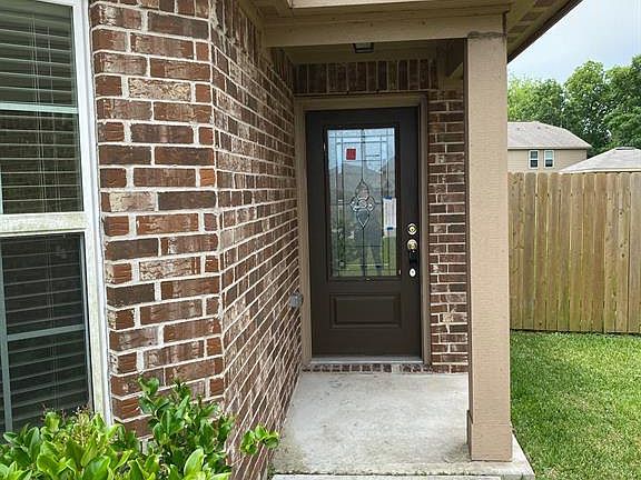 The front door of the home has a large leaded glass panel, allowing for lots of natural light to come in, while maintaining privacy in the home.