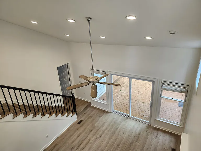 Large windows and glass door leading from the family room to the deck