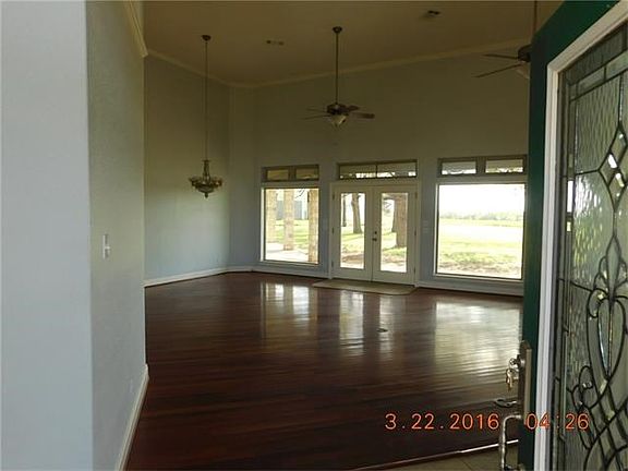 Family room and dining area from entry French doors leading to back porch and yard