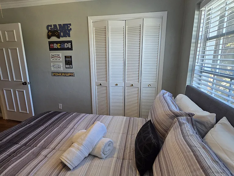 Well-lit bedroom with closet space and fresh towels included