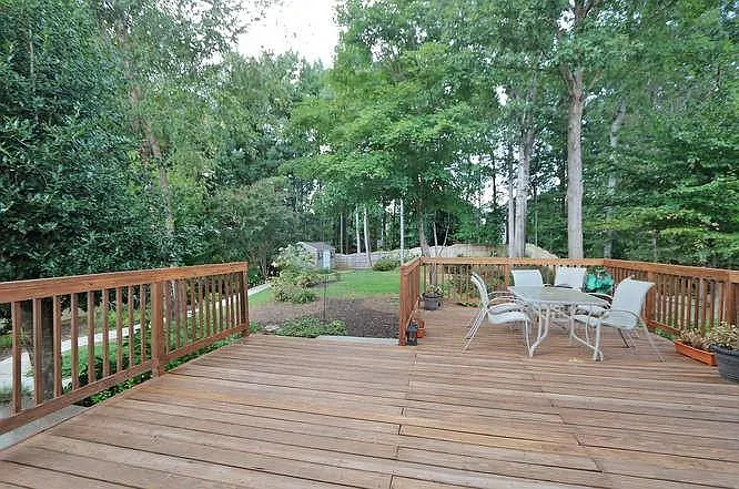 Expansive back porch overlooks the tranquil back yard . Notice the size of the back yard.