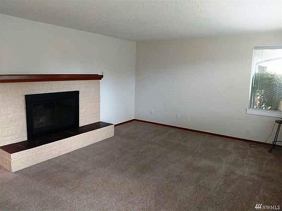 Imagine the Winter evenings around this beautiful wood fireplace. The carpet is new and there is original hardwood under it!