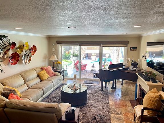 Furnished Living room with baby grand.
