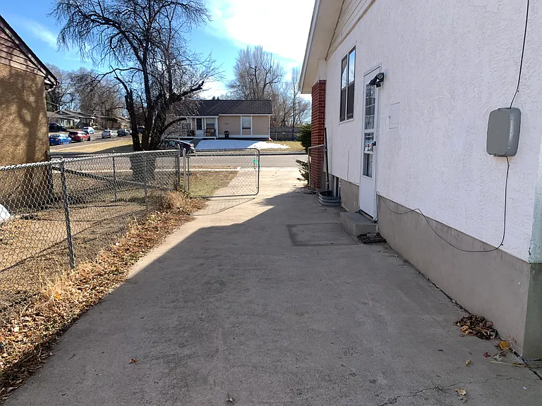 Driveway looking toward street. Side entrance.