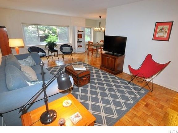 Living room opens to the "L" shaped dining room and has refinished parquet floors.  The room is 23'-4" x 12'-0" plus a entrance foyer.