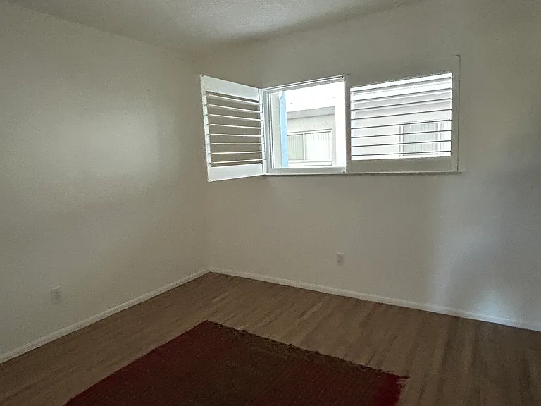 Guest bedroom with hurricane windows and light-reducing blinds