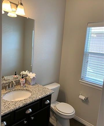 Powder room with quartz countertop on main floor