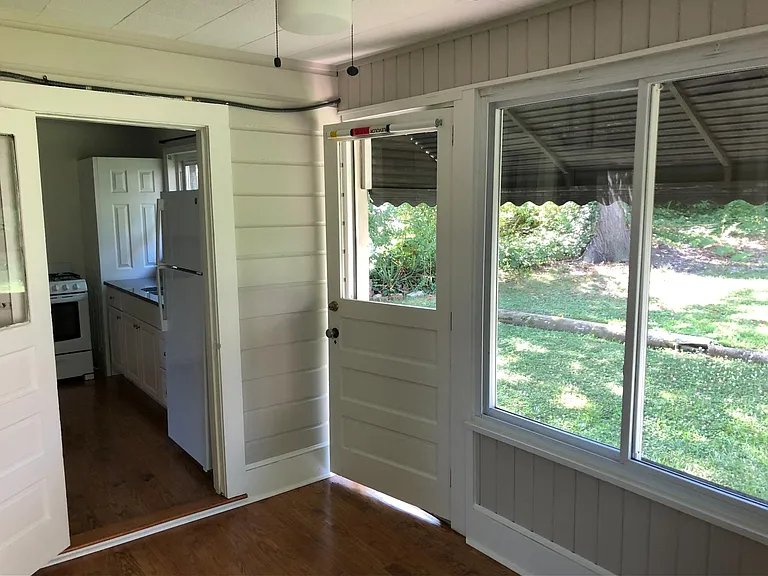 Spare room, view to kitchen and side door.