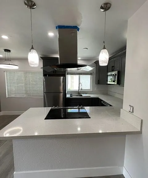 Large kitchen with Island and contemporary hood