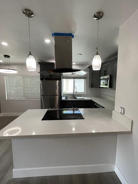 Large kitchen with Island and contemporary hood