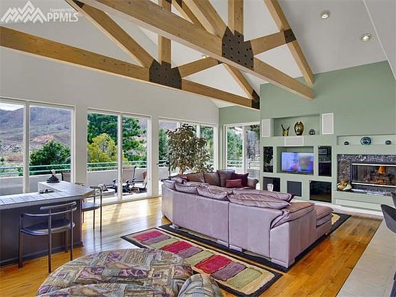 Great room with beamed ceiling, wall of windows and access to the large deck