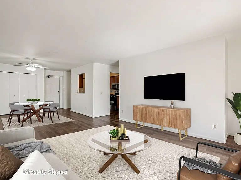 Enjoy comfortable living areas with space for seating and wall-mounted TV entertainment (virtually staged), professionally operated by Highlands Vista Group.