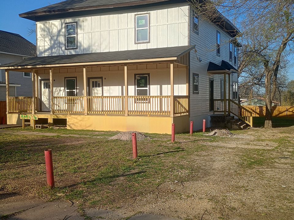 Front of property showing new (in progress) front porch. All new siding, new windows, new doors, and new front porch. Taken from where the driveway will be (in progress at time of picture).