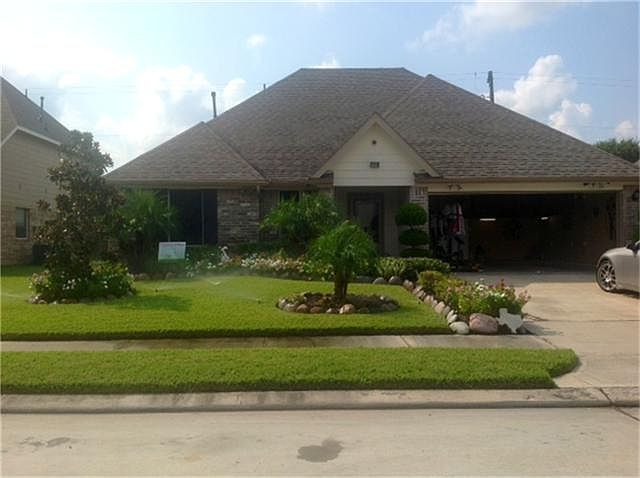 Lush landscaping welcomes you home to this one of a kind home