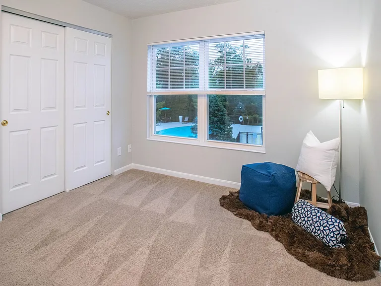 Spacious bedrooms featuring plush carpeting, large closets, and expansive windows.
