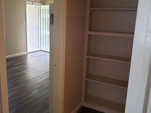 The front and back doors are all new and are security doors. There is shelving in the hallway for storage or for family photos, books or decorations to be placed.