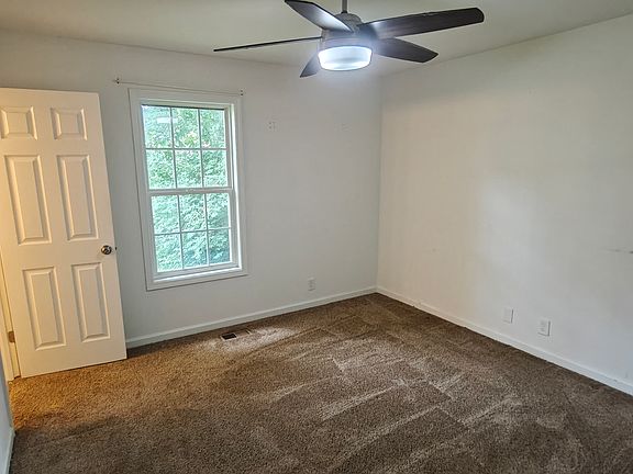 The master bedroom has new carpet, a ceiling fan, and more!